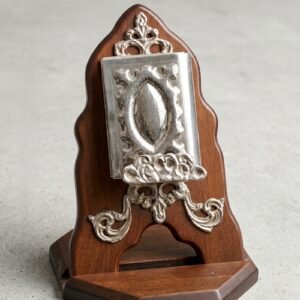 miniature quran with engraved silver case on arched wooden stand