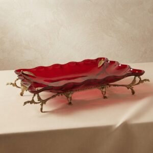 red rectangular bowl and bronze leaf