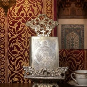 miniature quran with engraved silver cover on ornate silver stand