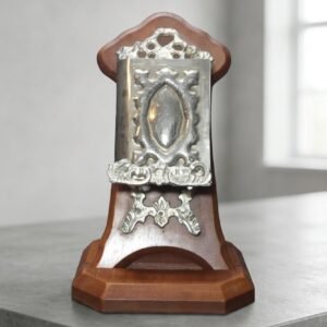 miniature quran with engraved silver case on wooden stand
